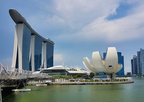SINGAPORE, SINGAPORE - May 7, 2017: Marina Bay Sands luxury complex with the DNA Helix Bridge and the ArtScience Museum iconic lotus architecture.