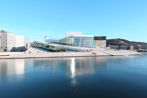 Oslo, Norway - February 28, 2019: The Oslo Opera House Is The Home Of The Norwegian National Opera And Ballet. The Roof Of Building Angles To Ground Level Creating A Plaza Inviting Pedestrians To Walk Up And Enjoy Views Of Oslo.