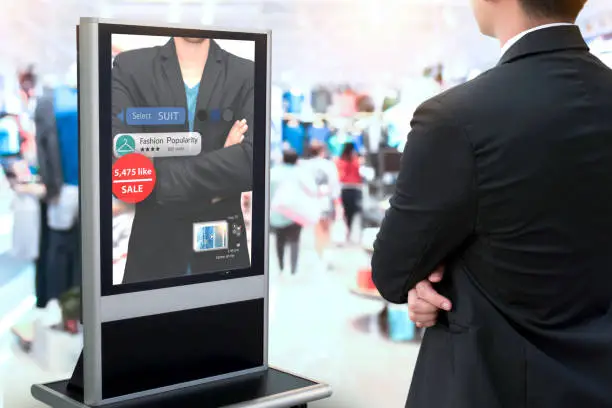 Intelligent Digital Signage , Augmented reality marketing and face recognition concept. Smart glass interactive artificial intelligence digital advertisement in fashion retail shopping Mall.