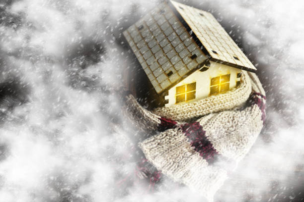 istock environmentally friendly warm home wrapped in a soft comfortable scarf. Snow is on the small house, snowstorm, snow. Concept of protection, warmth, coziness 1139529156
