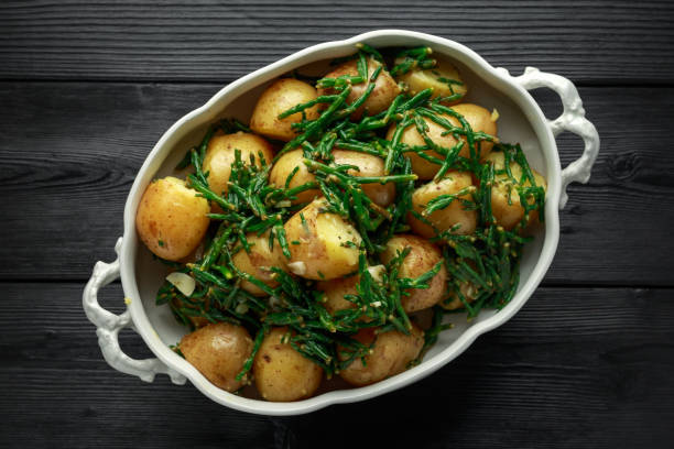 Boiled new potato with fresh samphire and garlic Boiled new potato with fresh samphire and garlic. salicornia europaea stock pictures, royalty-free photos & images
