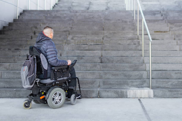 istock Man on a wheelchair looking at stairs 1139530045