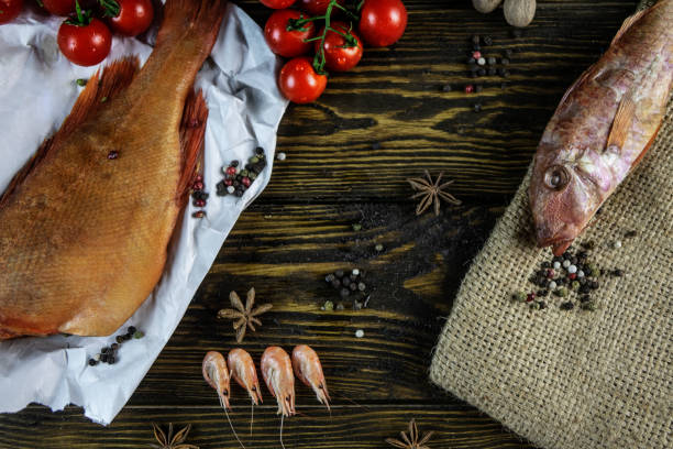 istock Seafood and cherry tomatoes on a rough wooden background 1139530103