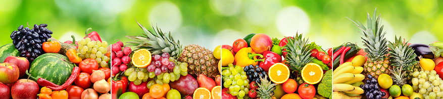Panoramic skinali from bright fresh vegetables, fruits, berries on green natural blurred background.