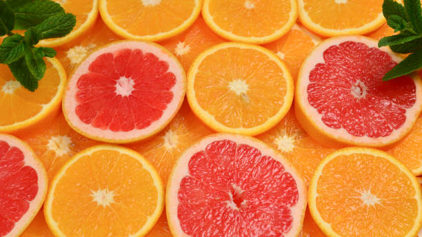 istock Slices of oranges and a grapefruits and mint as a background. 1139530326
