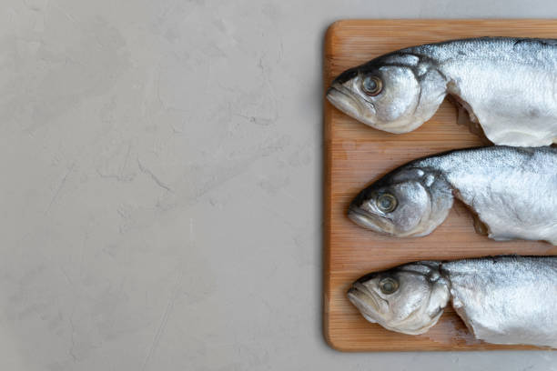istock Raw fish on wooden board. 1139533125