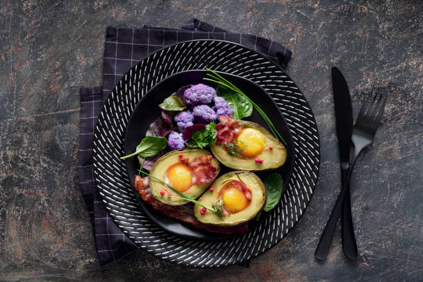 istock Baked avocado with egg and bacon ,flat lay on dark background 1139533451