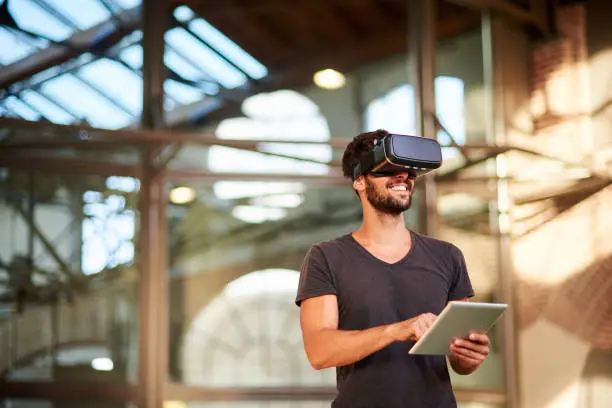 Photo of Man using virtual reality simulator headset