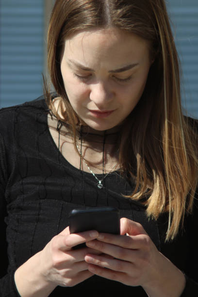 istock Young woman outside on her mobile phone 1139535289