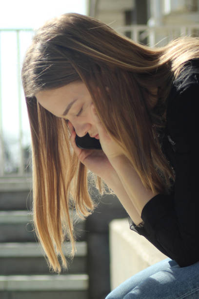 istock Young woman outside on her mobile phone 1139535357