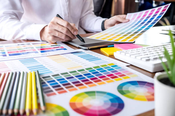istock Image of male creative graphic designer working on color selection and drawing on graphics tablet at workplace with work tools and accessories 1139535375