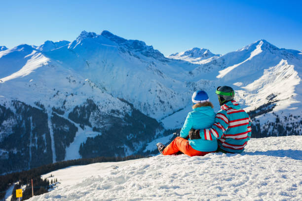 istock Skier and snowboarder at rest in long chairs 1139535522