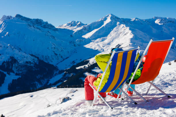 istock Skier and snowboarder at rest in long chairs 1139535692