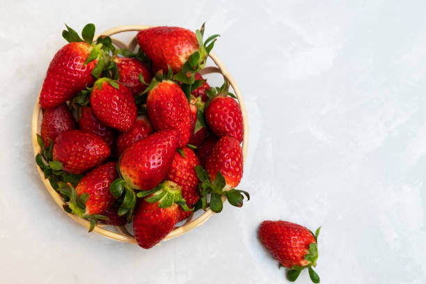 istock Fresh strawberries in a basket on neural background 1139535869