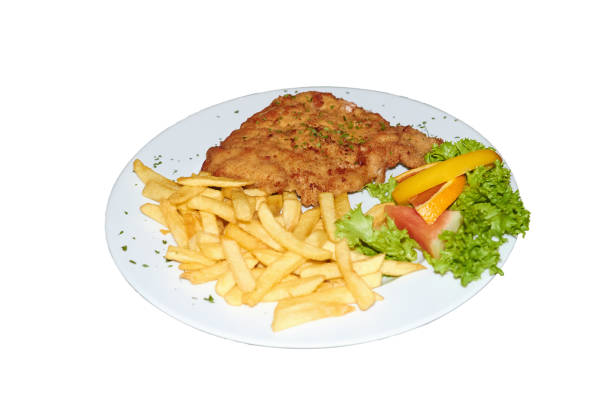 istock Plate with schnitzel, orange slice close up, isolation on white. 1139536701