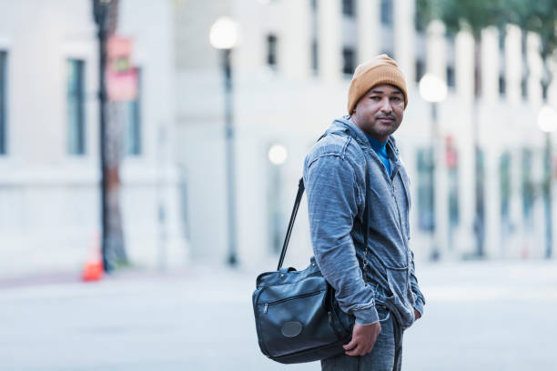 istock Mature Hispanic man standing on city street corner 1139538538