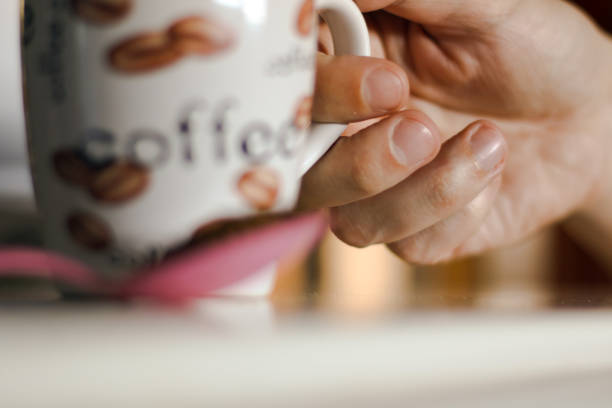 istock Man's hand holding cup of coffee 1139539103