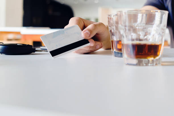 istock Close up on hand holding a payment debit credit card at cafe paying for drinks 1139540623