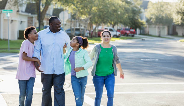 istock Interracial family, two children, taking walk together 1139541717