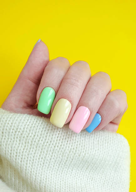 istock female hand colored manicure sweater 1139544954