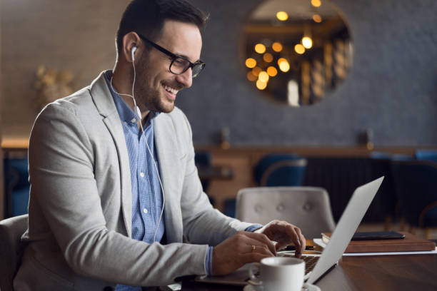 istock Businessman listening to the music while working on a computer. 1139550719