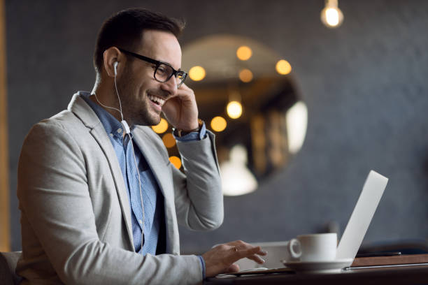 istock Businessman listening to the music while working on a computer. 1139550733