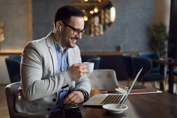istock Businessman listening to the music while working on a computer. 1139550744