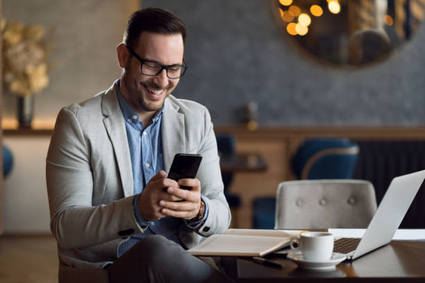 istock Businessman reading a text message on cell phone at cafe 1139550759