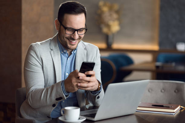 istock Happy businessman text messaging on cell phone 1139550931