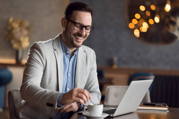 istock Happy businessman using laptop in a cafe. 1139550965