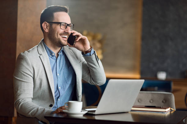 istock Smiling  businessman talking on a mobile phone 1139550980