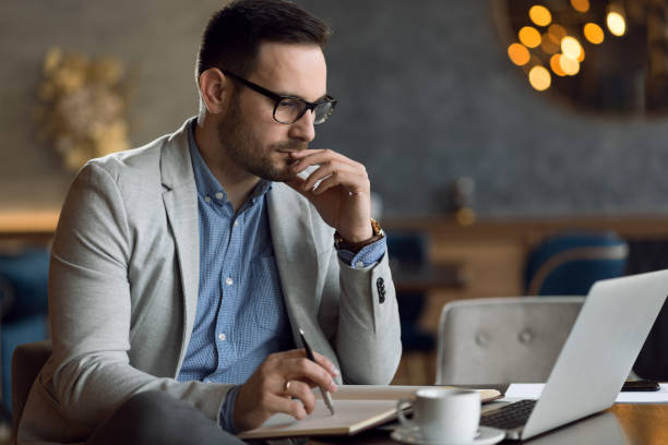istock Thoughtful businessman writing business reports in a cafe 1139551027