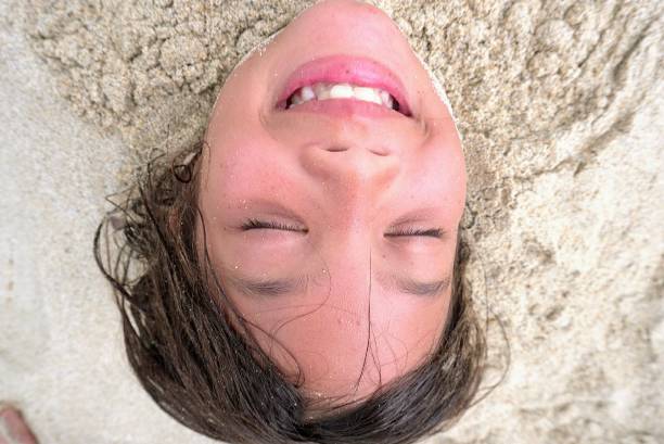 istock Closed-up with face expression - digging hole in sandy beach - vacation in Kona Hawaii 1139551665
