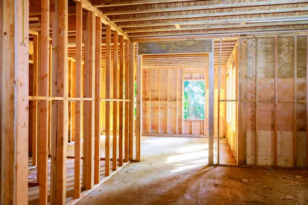 Photo of New house under construction framing against