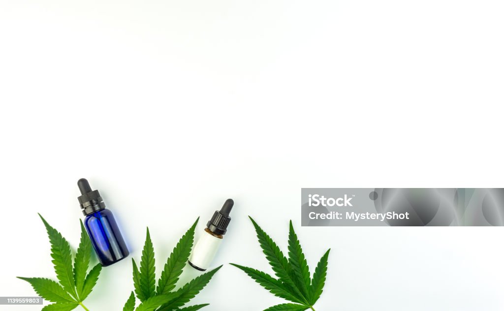 Marijuana leafs and cannabis oil bottles isolated On white Marijuana leafs and cannabis oil bottles isolated On white top view Hemp Stock Photo