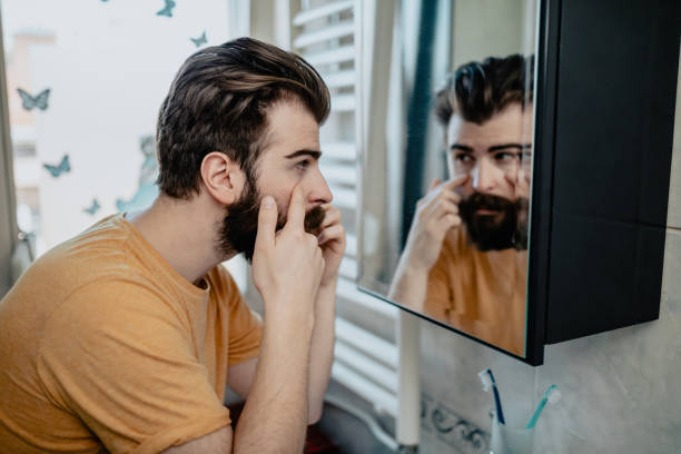 istock Man looking in the mirror in the bathroom 1139561189
