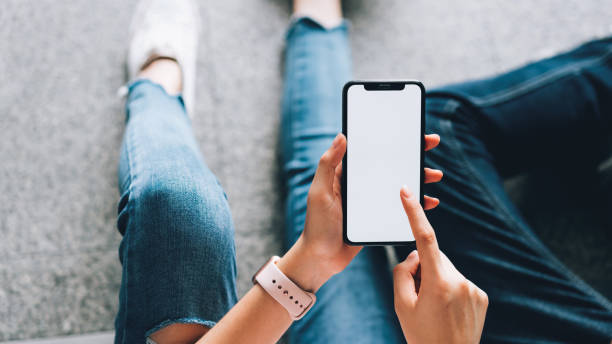 close up da mulher que prende um smartphone, mock acima da tela em branco. usando o telefone celular no estilo de vida. tecnologia para o conceito de uma comunicação. - agenda de telefones - fotografias e filmes do acervo