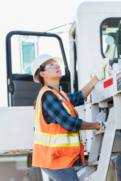 istock Female crane operator climbing on vehicle 1139563087