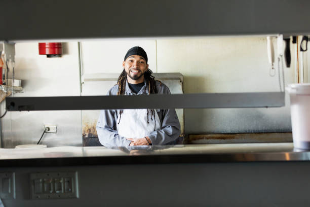 istock Mixed race man with dreadlocks in commercial kitchen 1139563911