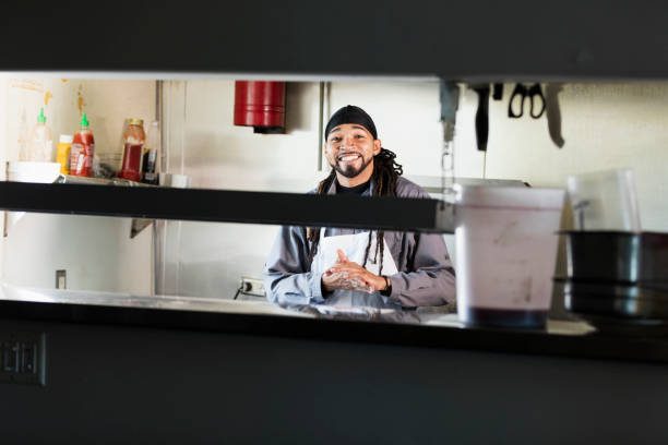 istock Mixed race man with dreadlocks in commercial kitchen 1139563972