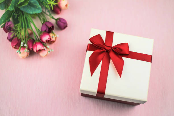 istock Gift with flowers on pink textile background. 1139567967