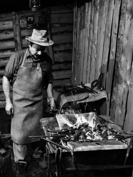 Blacksmith manually forging the molten metal