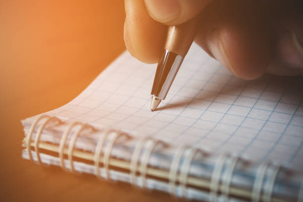istock Pen and white notepad paper close up in man's hand 1139569672