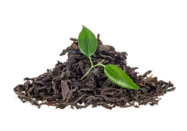 istock Dry black tea with green leaves isolated on white background 1139571412