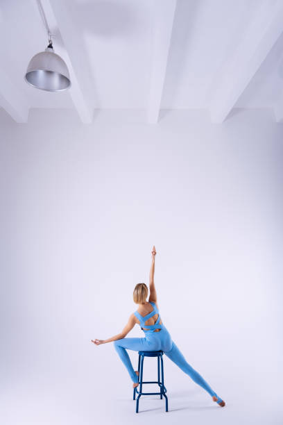istock Attractive gracious woman raising her hand up 1139571482