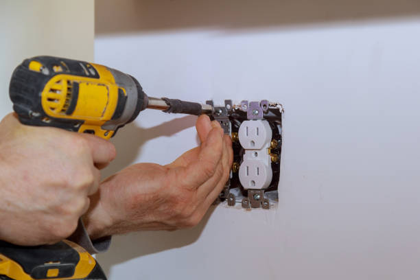 istock Electrician installs lighting switch in the wall 1139582508
