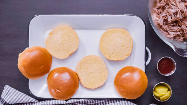 istock Making pulled pork sandwiches with coleslaw on brioche buns. 1139583418