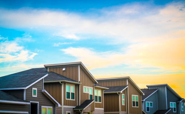 Real Estate Suburb New Development in Austin , Texas , USA - evening afternoon sunset bright sunshine on front yards and facade of new homes in Central Texas Neighborhood