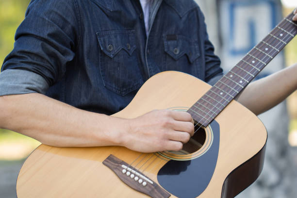 istock Playing on acoustic guitar outdoor 1139588032