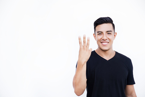 Handsome latin hispanic man is showing three fingers isolated on white background. Place for text and design.
